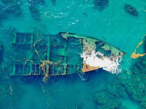 Free Old Abandoned Boat Deteriorating in a Coastal Water Stock Photo