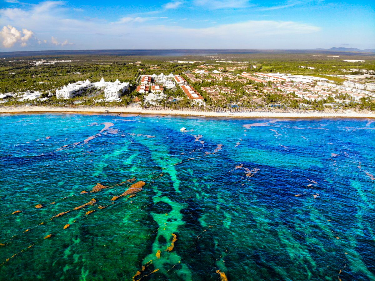 Aerial view of a coastal town with turquoise water and shoreline development