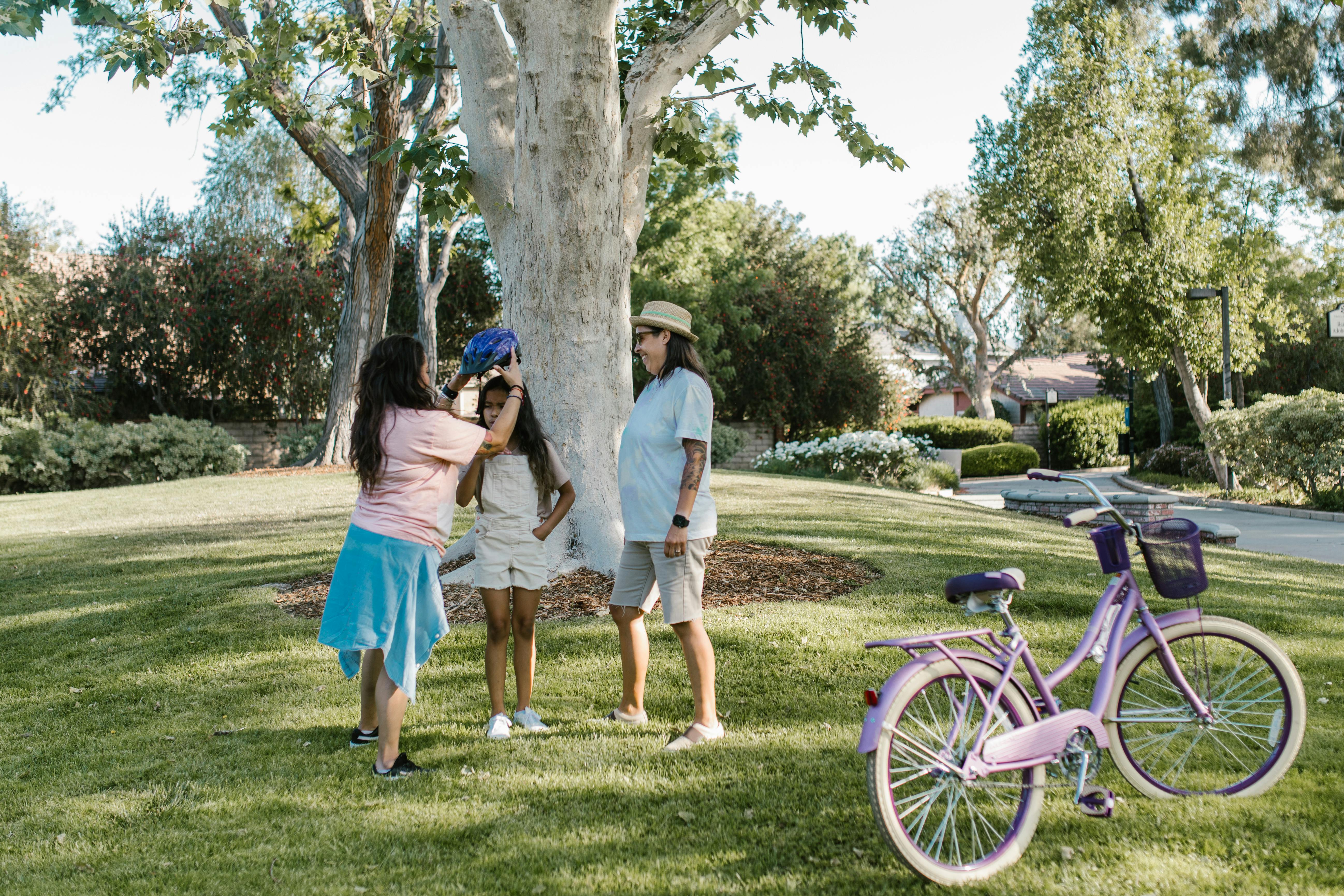 A family enjoying a sunny day in the park with bicycles, capturing togetherness and leisure.
