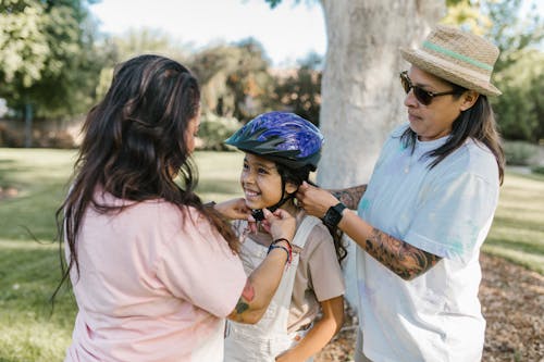 Parents Wearing a Helmet to a Young Girl