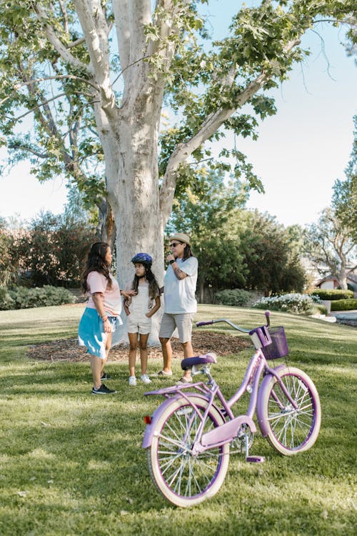 A Family Standing Beside the Tree