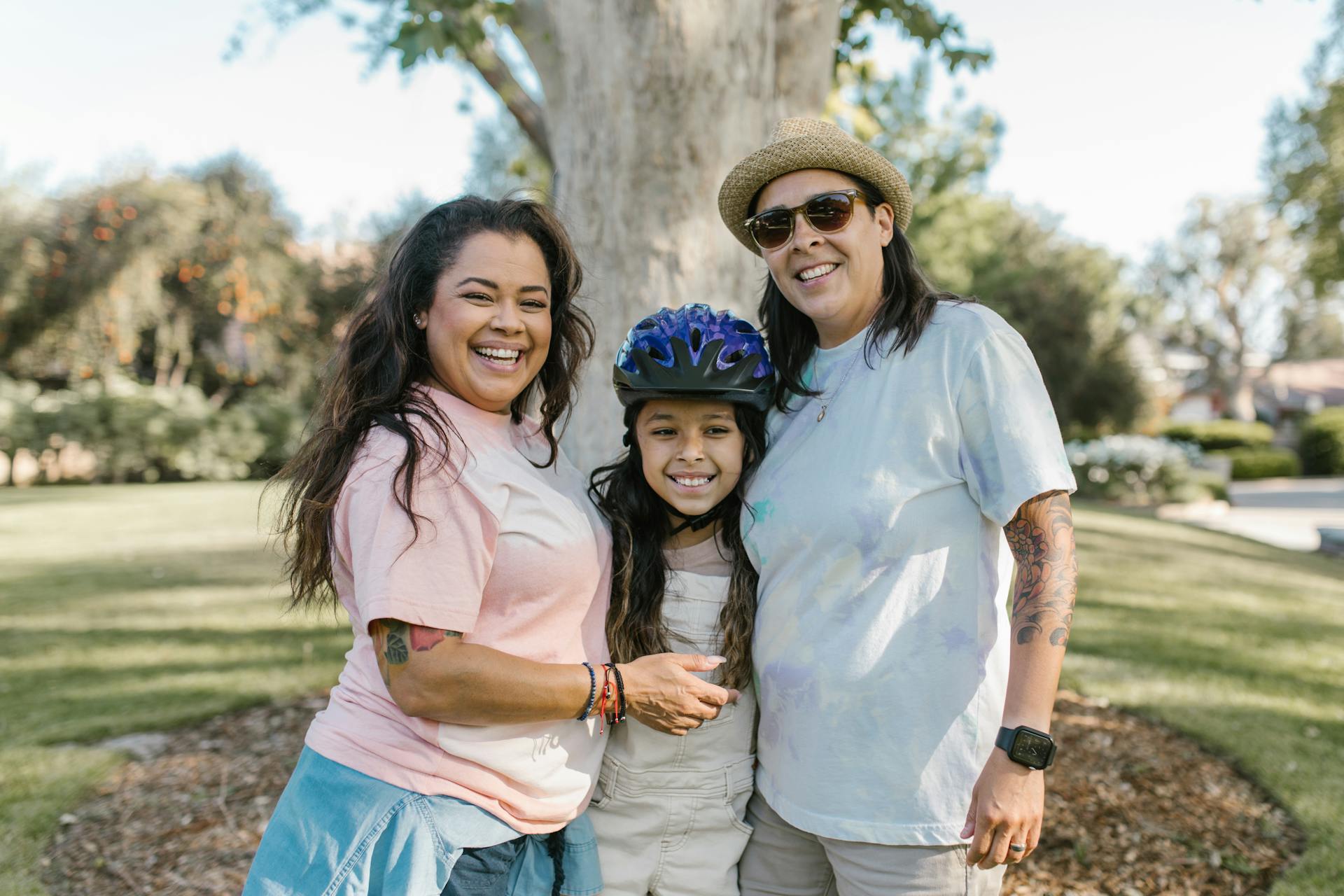 Cheerful family with two parents and a child enjoying a sunny day outdoors, capturing moments of joy and togetherness.