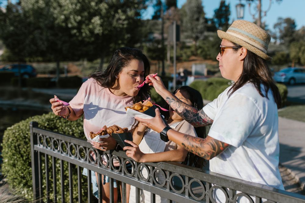 A family sharing snacks together on a sunny day