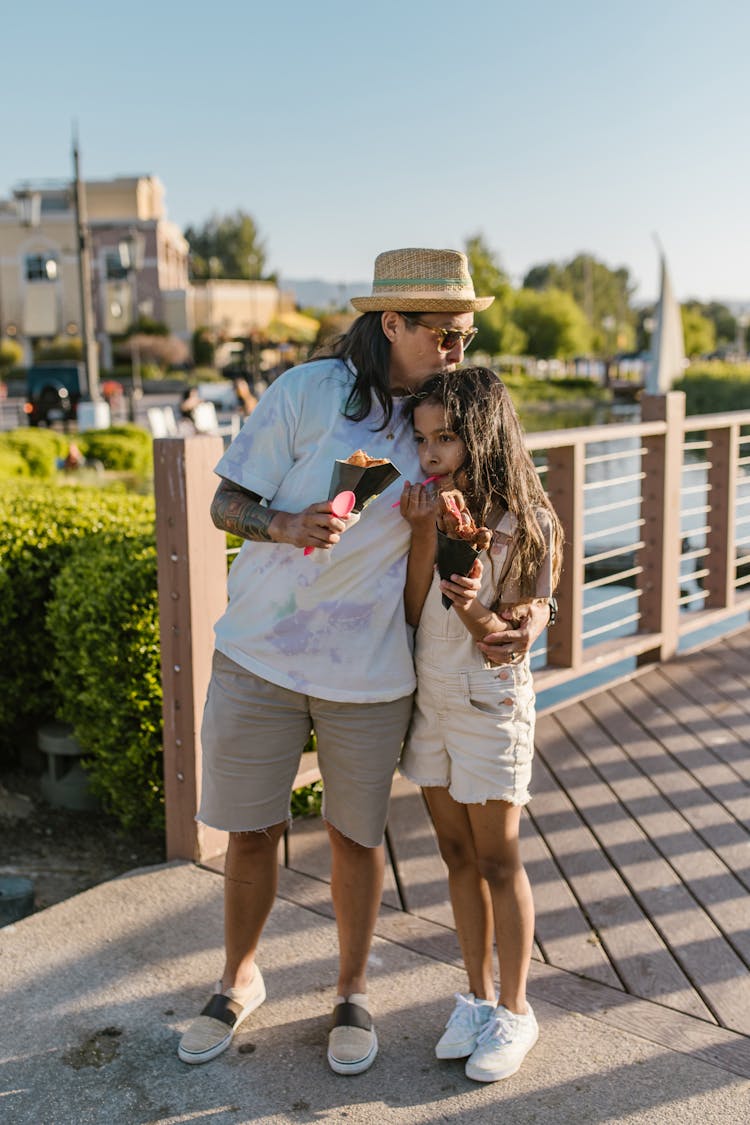 A Parent And Daughter Eating Sweets