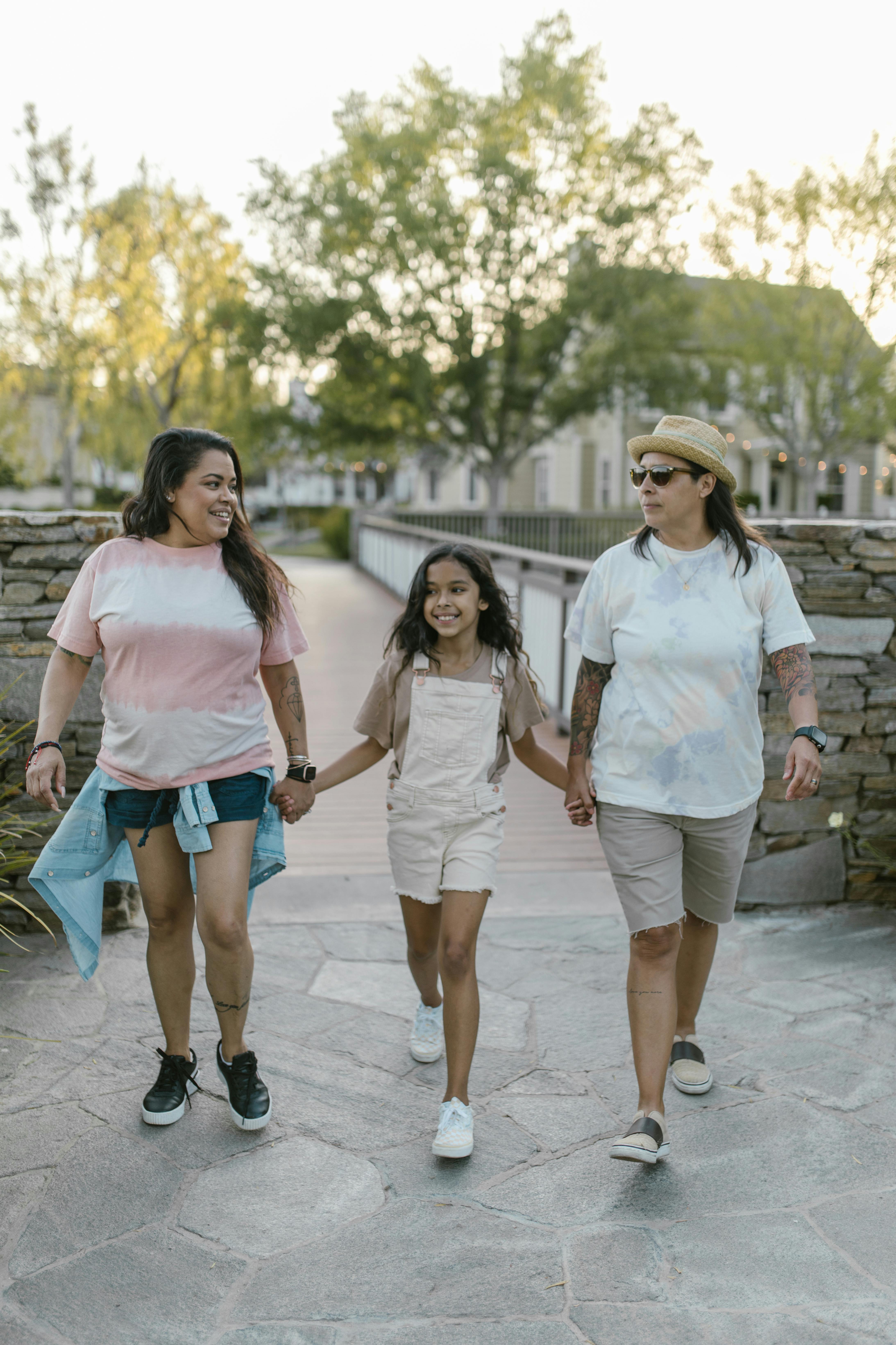 a family holding hands while walking