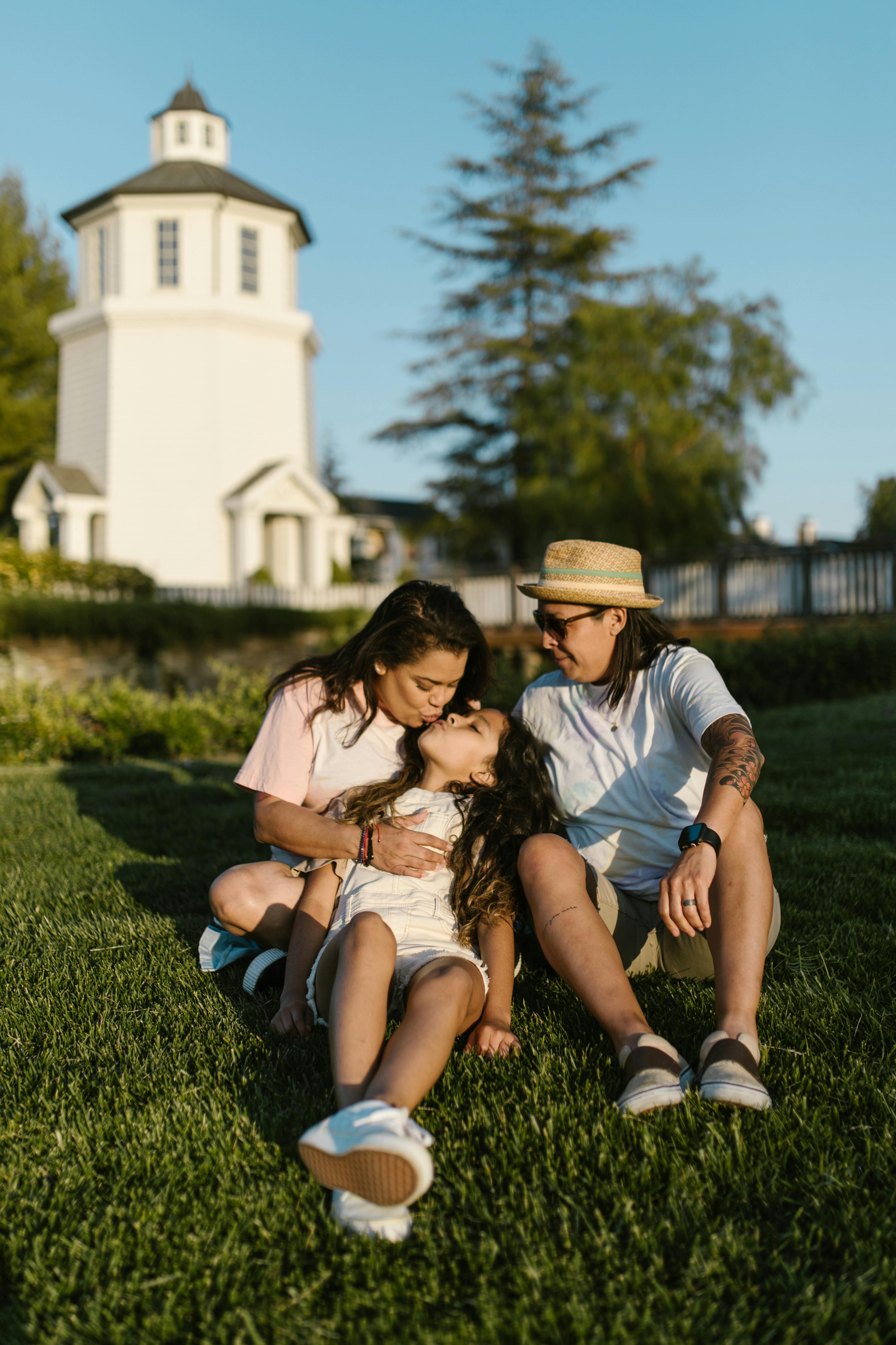 a family sitting on green grass