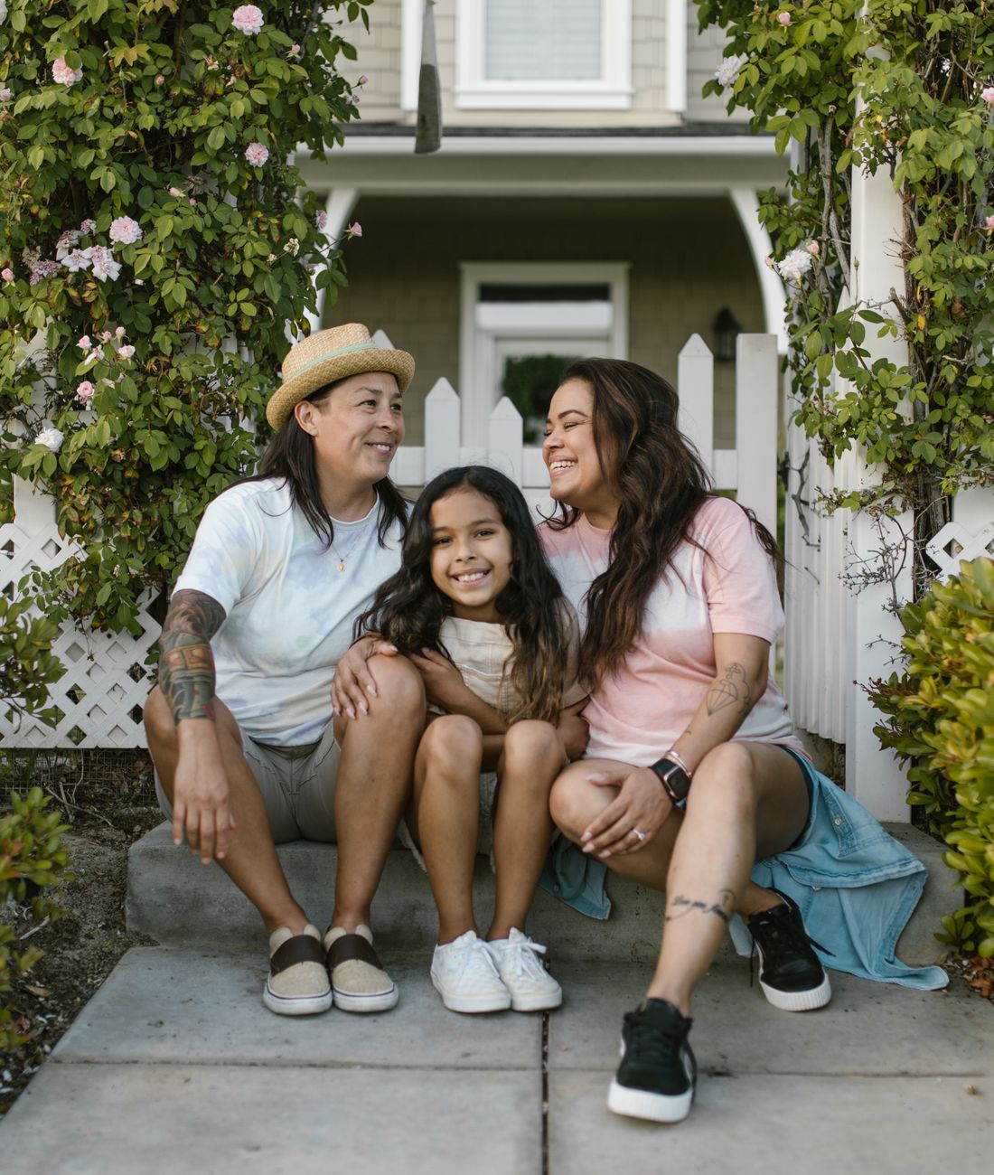 A family sitting together outside their home