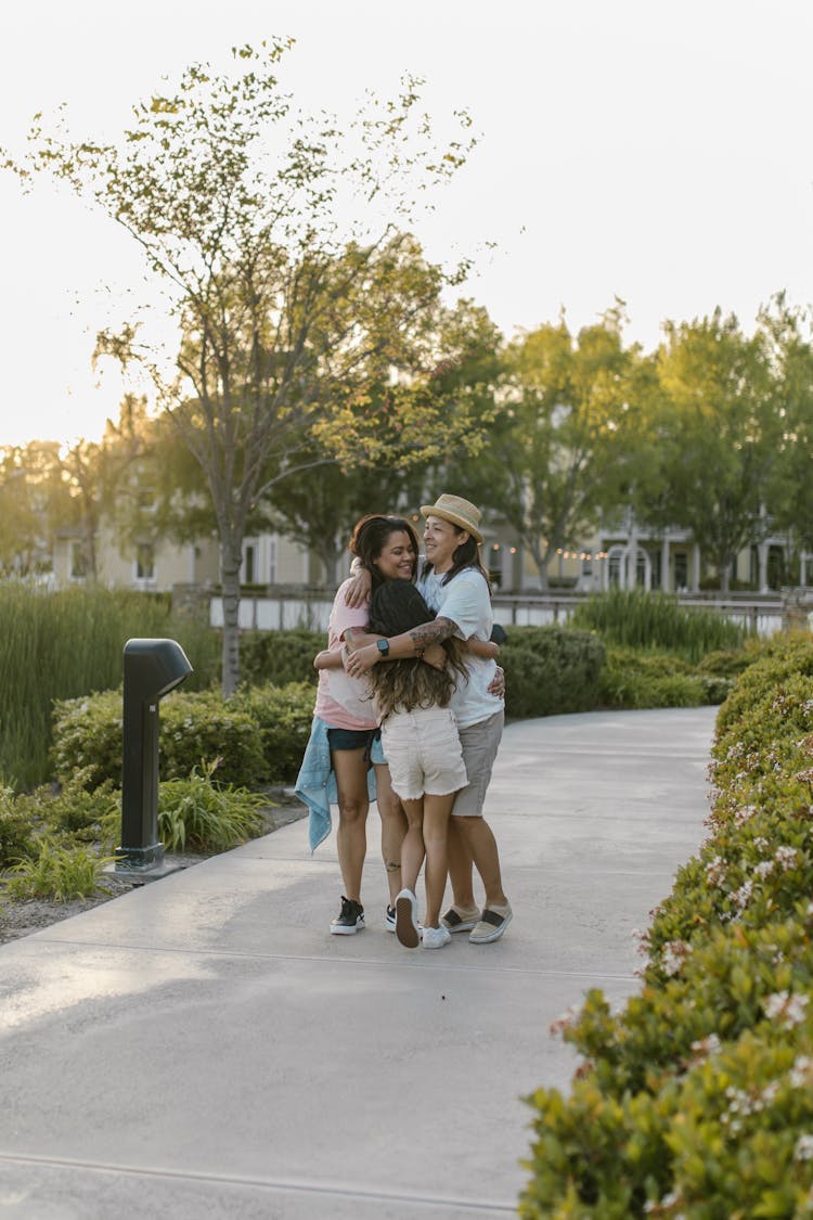 Happy Family Standing On Concrete Pathway
