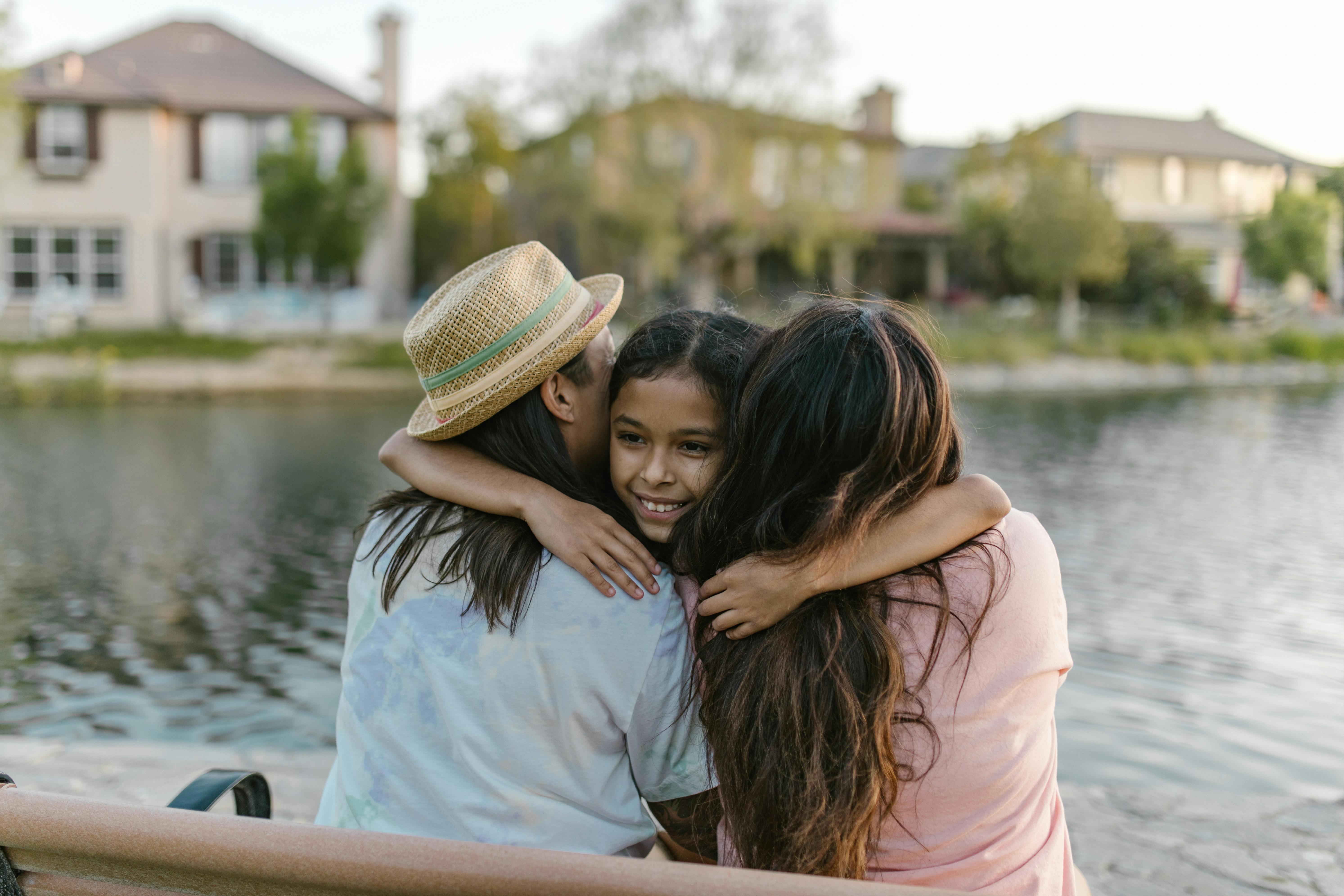 a daughter embracing her parents