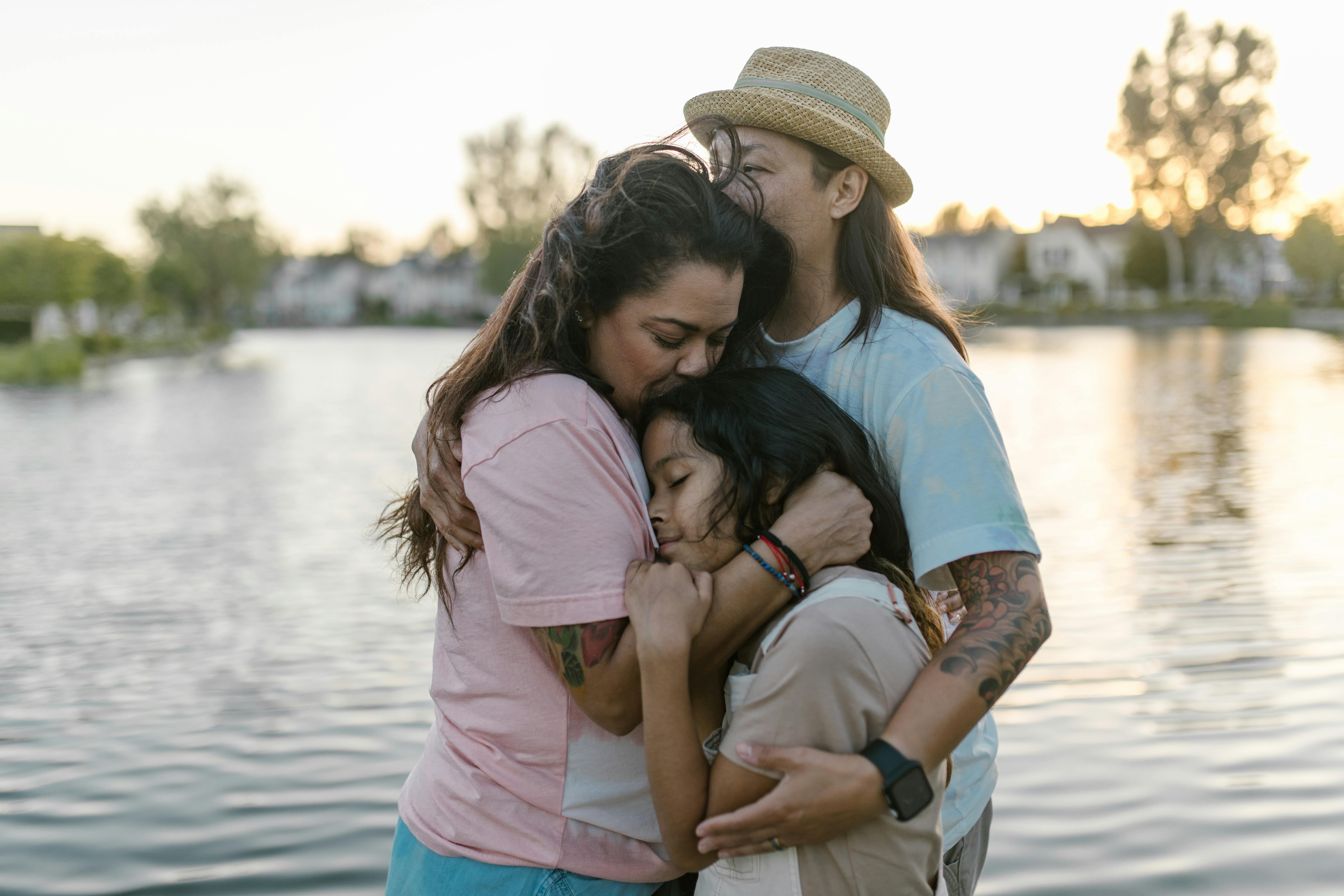 a daughter embracing her parents