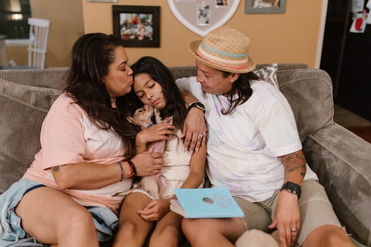 A Mother Kissing Their Daughter