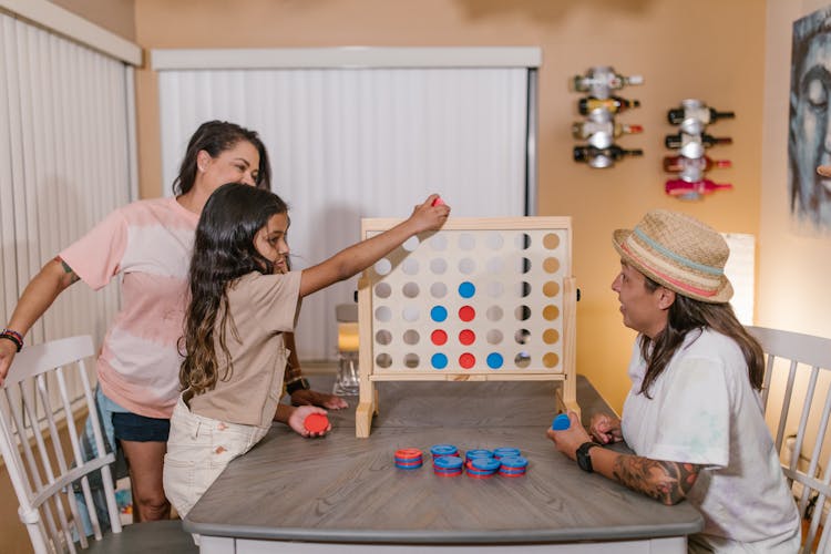 Family Playing Connect Four Game Together