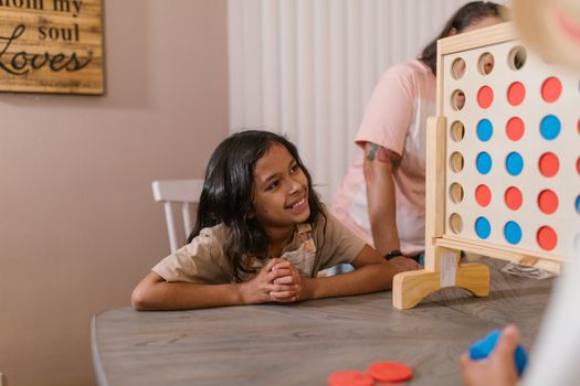 A Family Playing Connect Game at Home