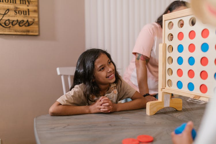 A Family Playing Connect Game At Home