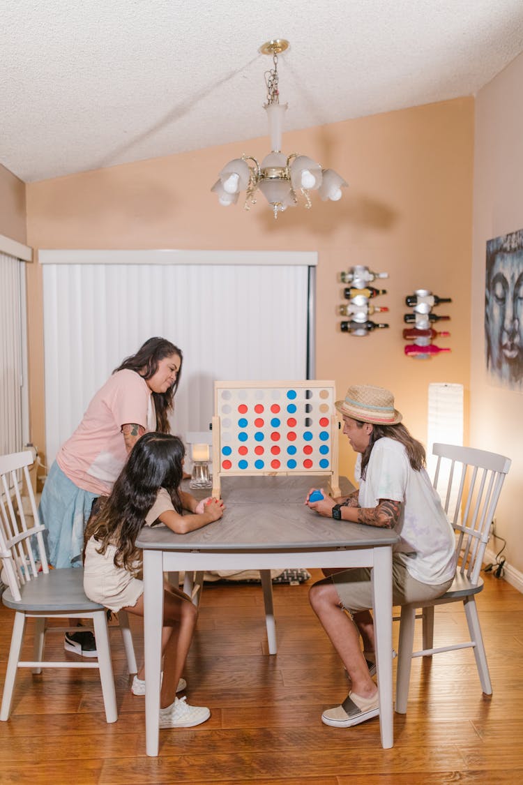 Family Playing Connect Four At Home