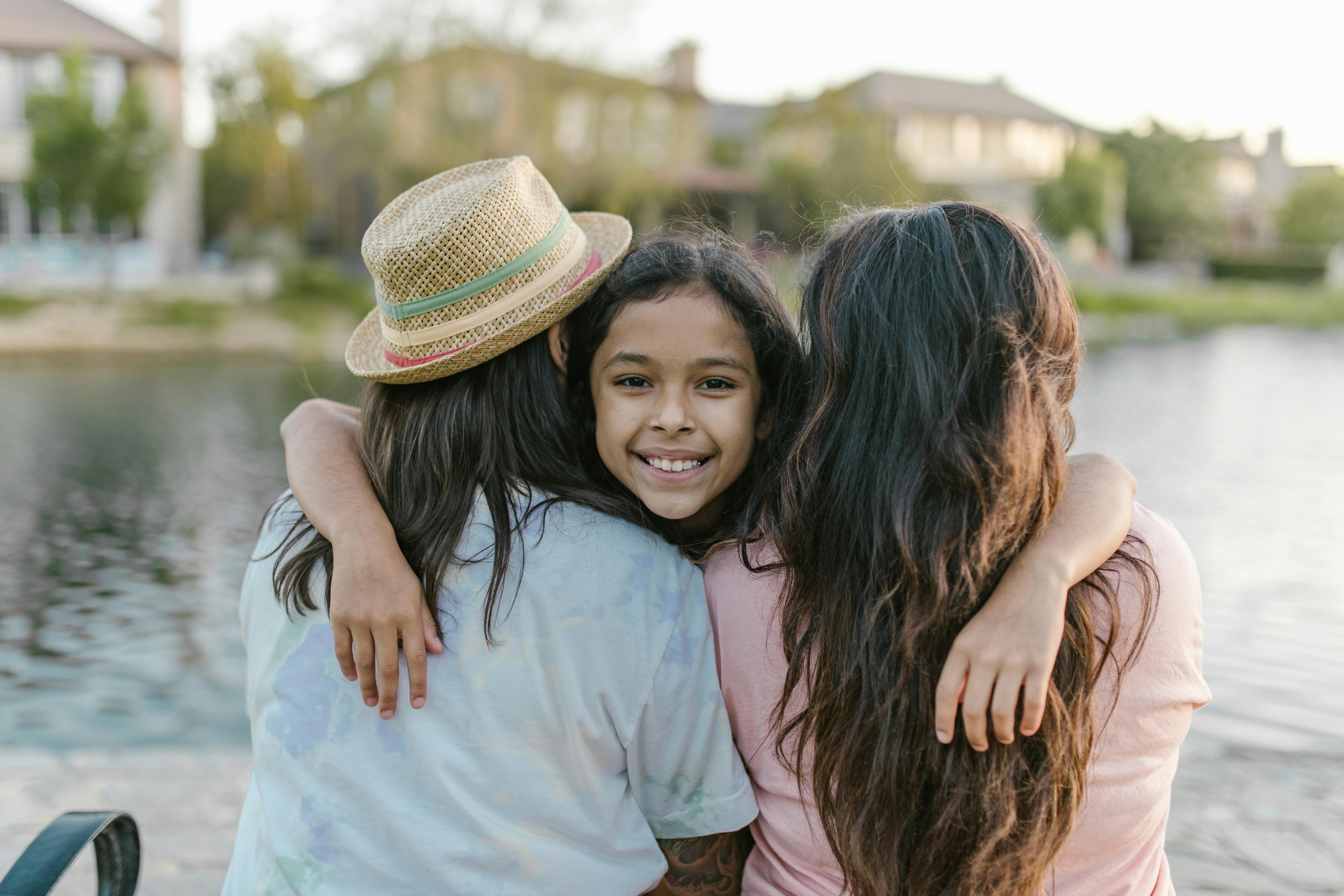 a girl embracing her parents