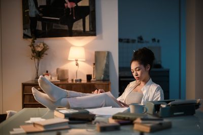 Writer at a desk at night, photo by Ron Lach on Pexels