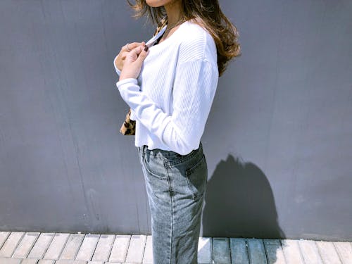 Woman Posing near Grey Wall