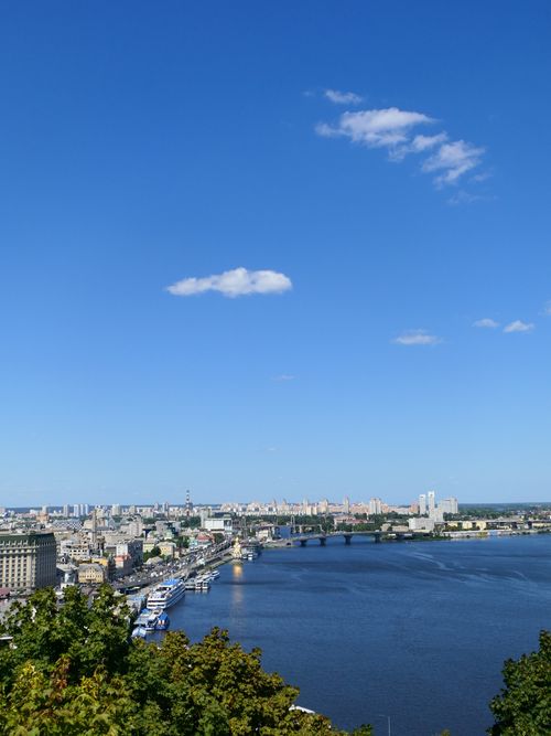 Free A breathtaking view of a city's skyline with a prominent blue sky and river. Stock Photo
