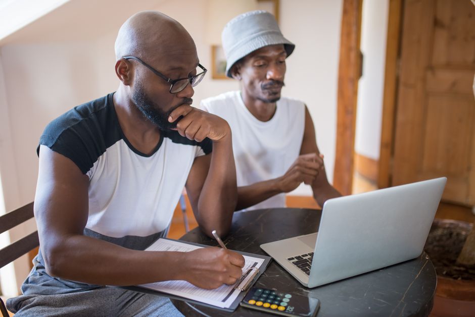 Couple looking at a mortgage application with a calculator