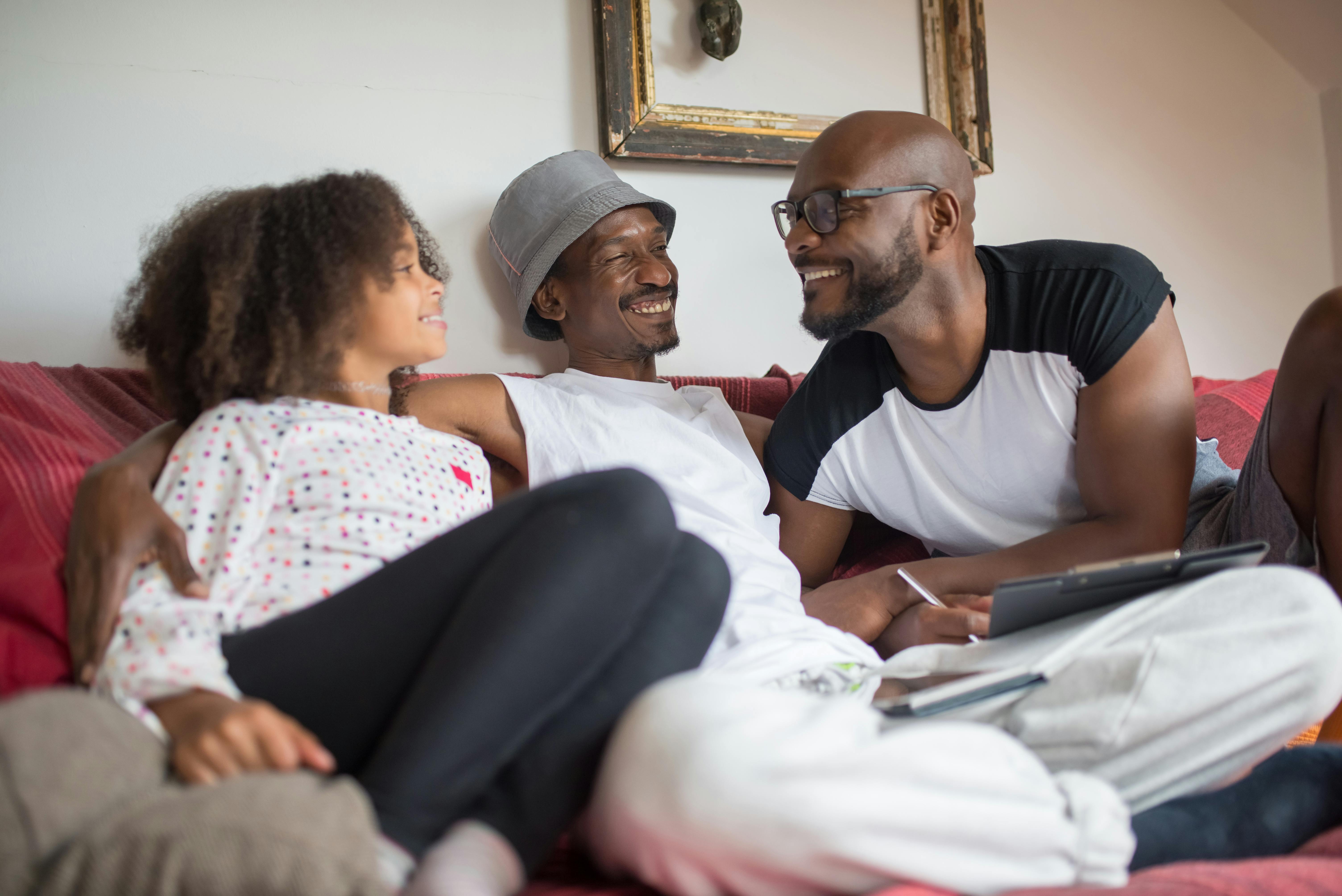 a happy family sitting on the couch while having conversation