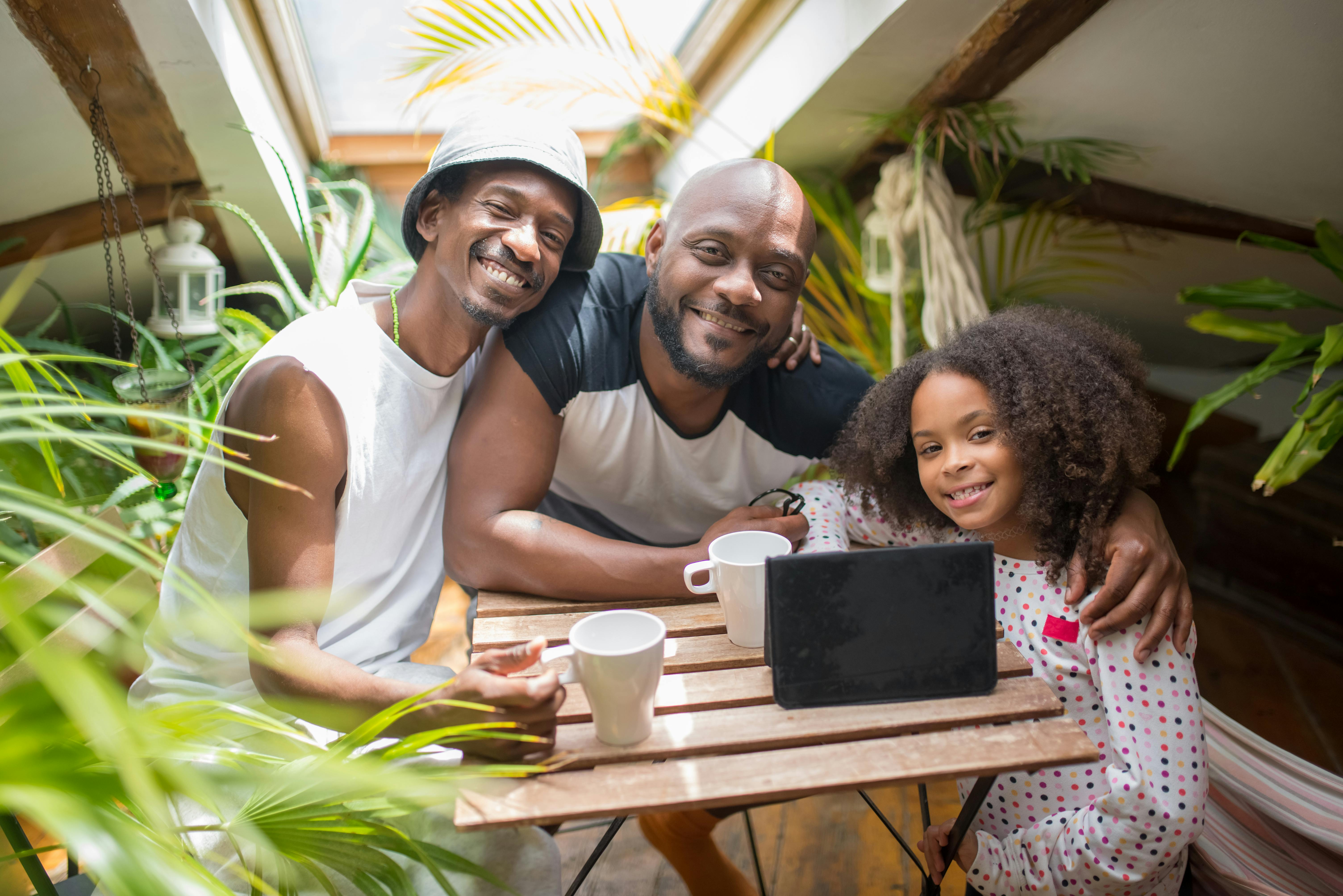 a happy family sitting near the wooden table