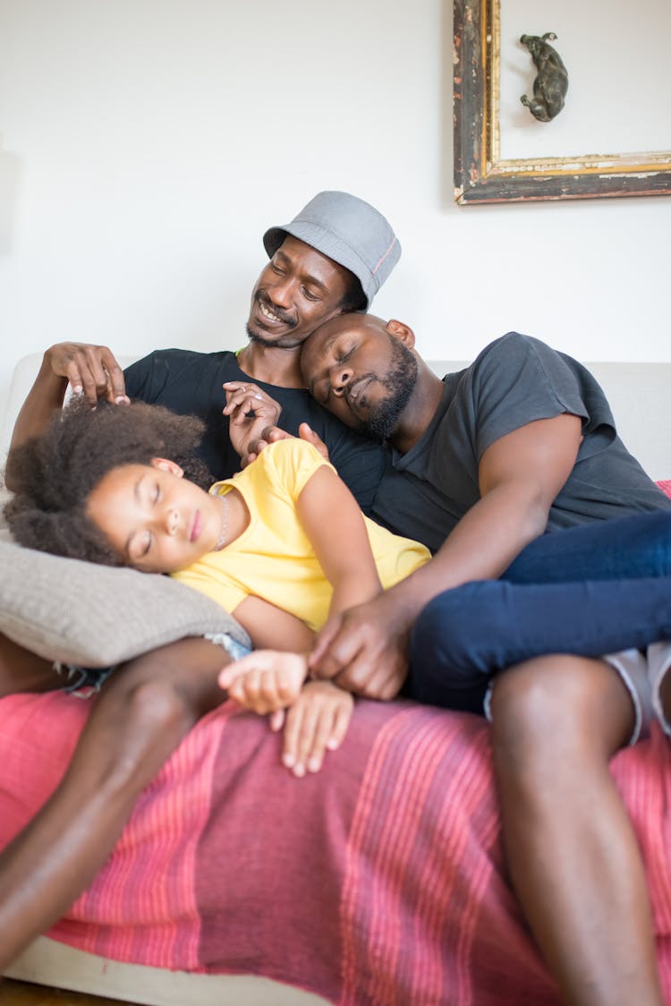 A Family Sleeping On The Sofa