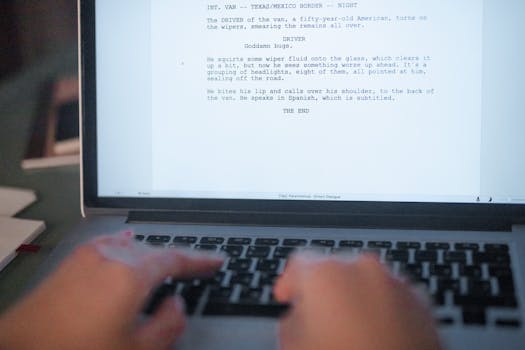 A close-up shot of hands typing a film script on a laptop, focusing on creativity and screenplay writing.