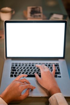 Close-up of hands typing on a laptop with a blank screen, ideal for design or technology themes.