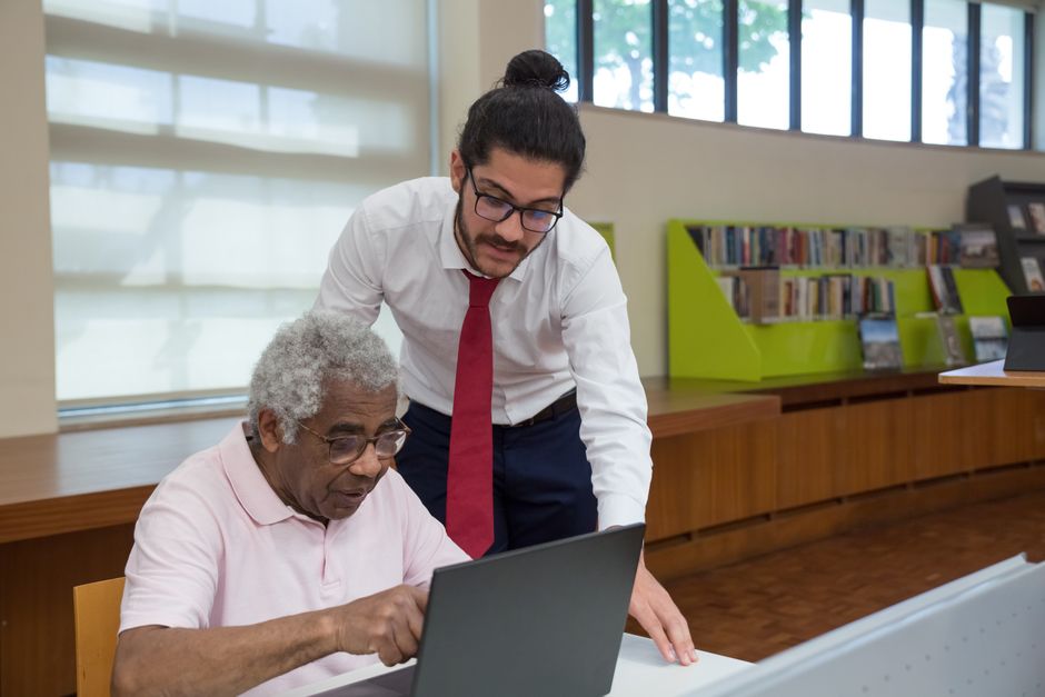 A senior and a lifestyle assistant reviewing a grocery list together on a tablet - senior grocery delivery A senior and a lifestyle assistant reviewing a grocery list together on a tablet - senior grocery delivery