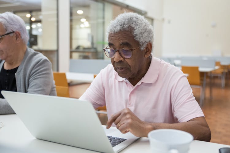 Elderly Men Sitting On White Table With Ceramic Cup