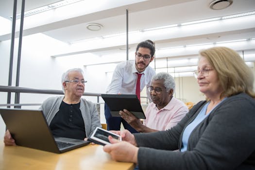 Elderly individuals engage in a digital learning workshop, embracing modern technology in a library setting.