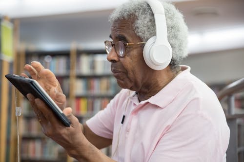 Free Elderly Man Wearing Eyeglasses Using Digital Tablet Stock Photo