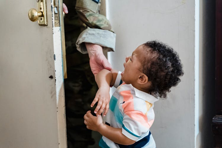 Unhappy Child Crying Unrecognizing Soldier Parent