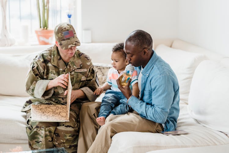 Family With Soldier Parent Looking Pictures In Album