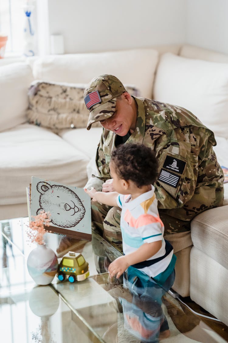 Woman In A Military Uniform Playing With Her Baby Son 