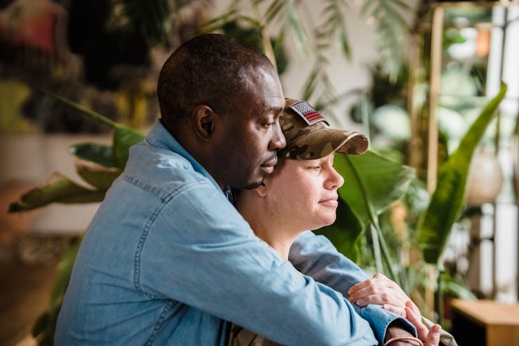 Man Holding Soldier Woman In Army Uniform