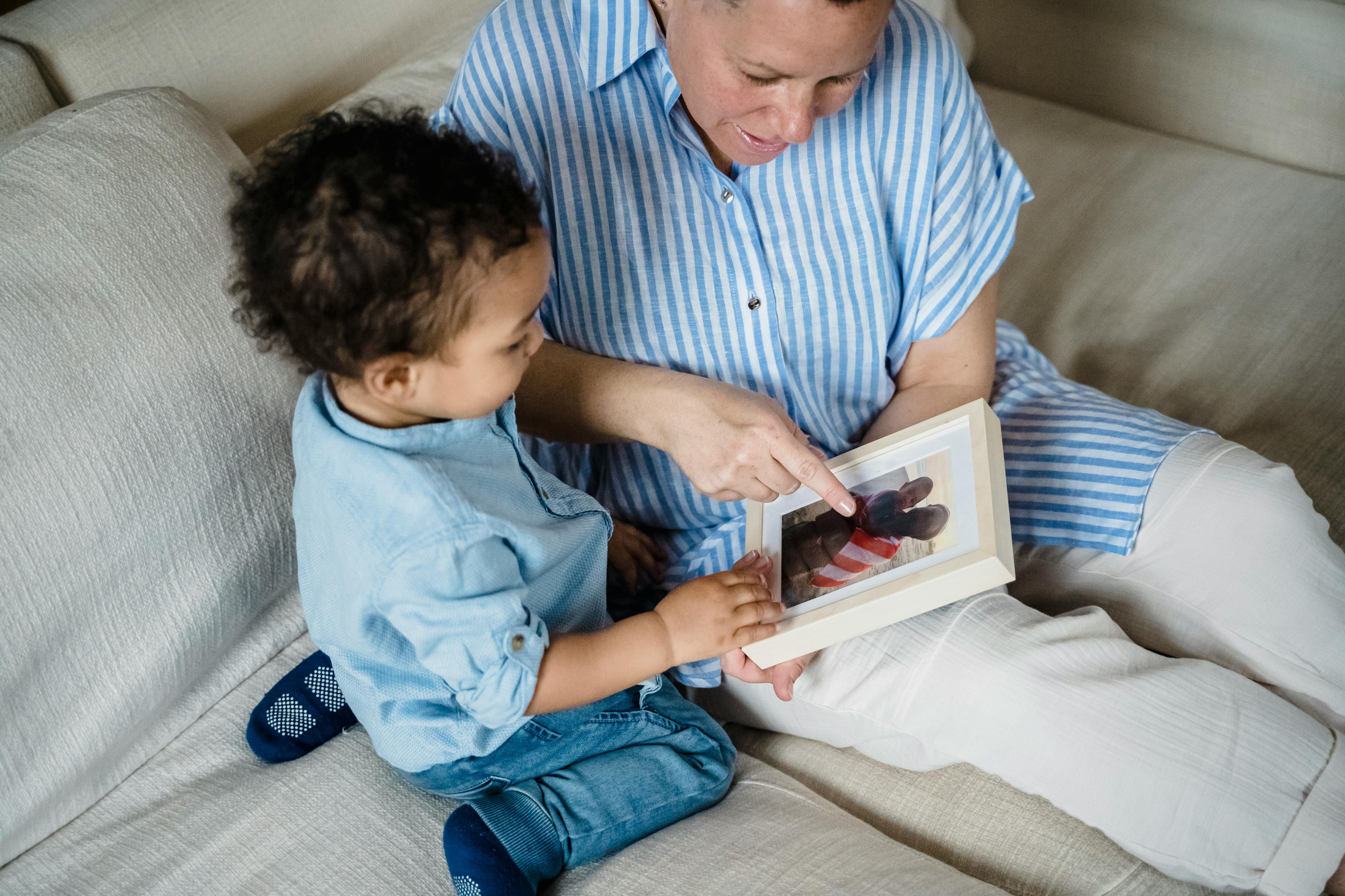 Free A Woman Showing a Child A Photograph Stock Photo