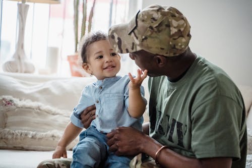 Free Cute Baby Playing with Father Soldier Stock Photo