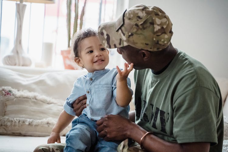 Cute Baby Playing With Father Soldier