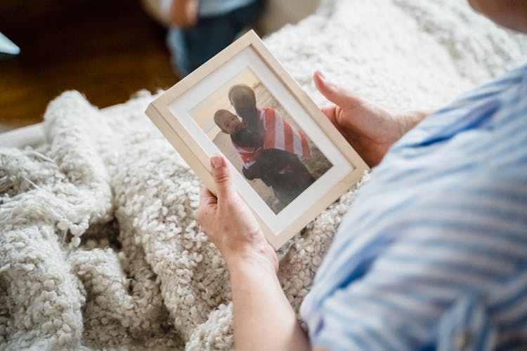 Woman Looking At A Family Picture 