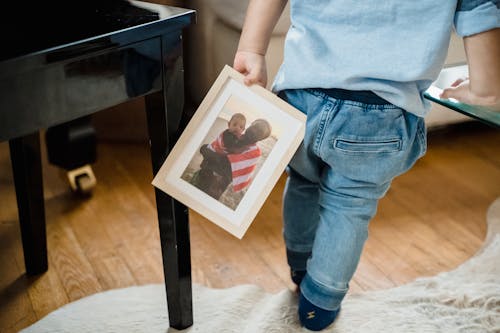 Free A Child Holding a Picture Frame Stock Photo