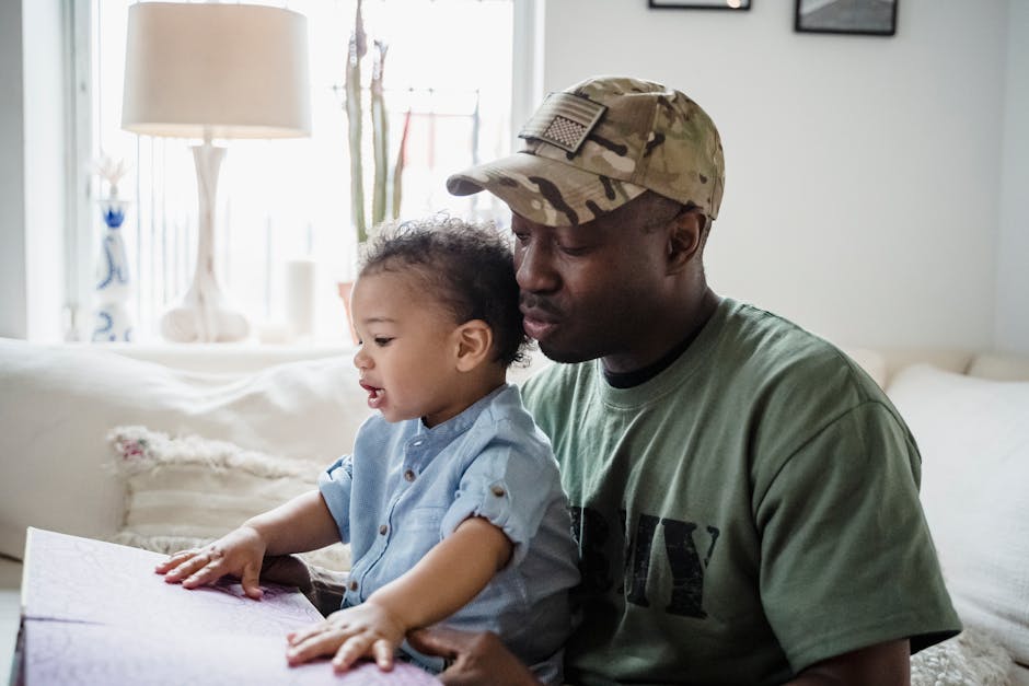 A father and child share a precious moment coloring together indoors, highlighting family bonds and closeness. - military ...