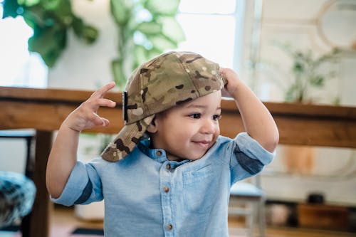 Free Boy Wearing Camouflage Cap and Blue Denim Shirt Stock Photo
