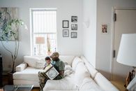 A Father and Child Sitting on the Sofa