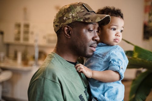 Free Man Carrying His Son Stock Photo