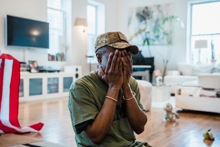 A Man With His Hands Covering His Face