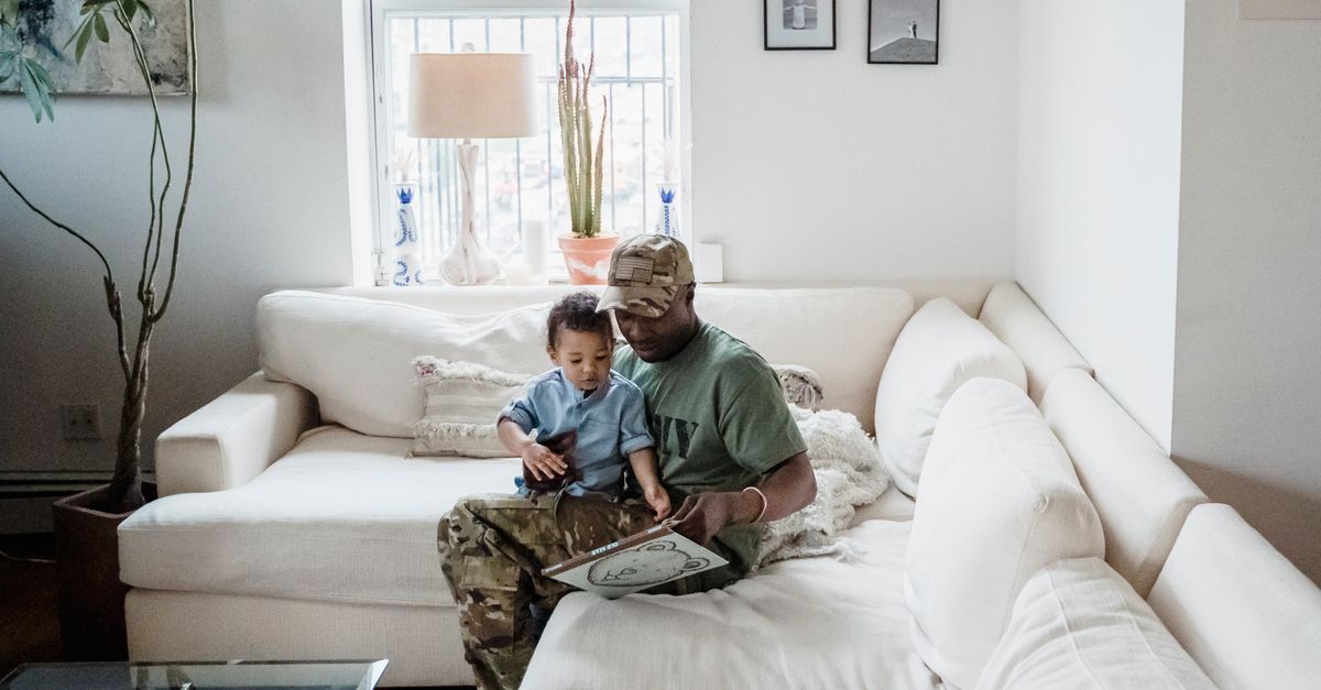 parent and child reading together on couch cozy evening