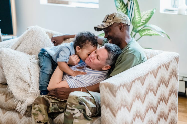 Family Cuddling Together On Couch