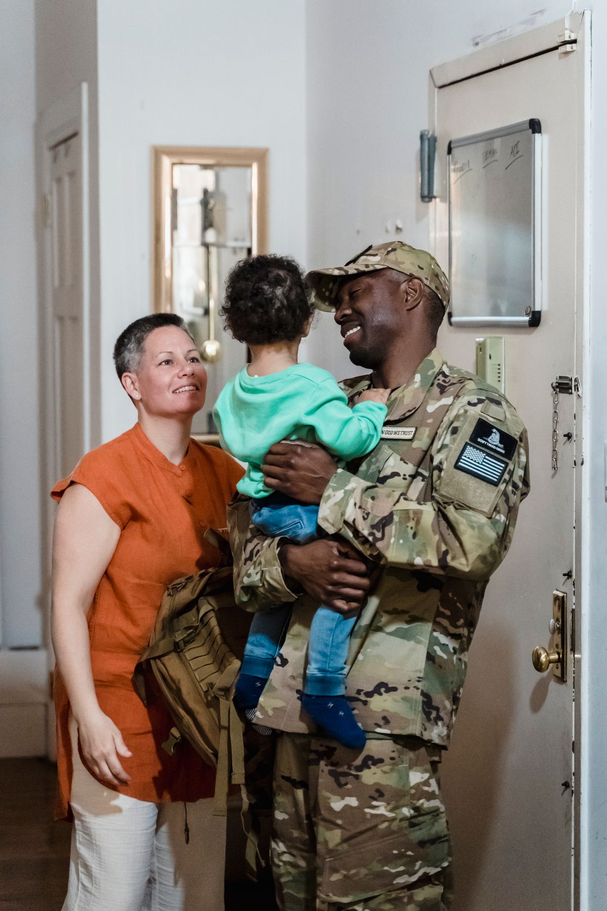 Service member reuniting with family at home